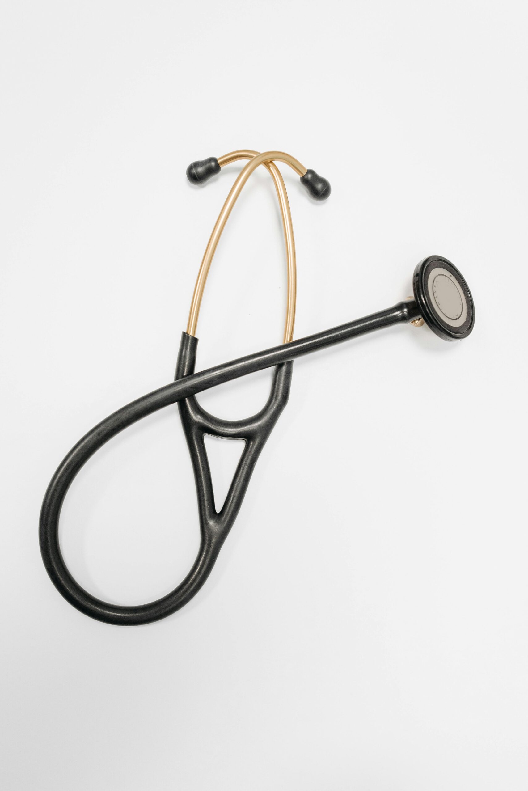 Close-up of a stethoscope on a white surface, ideal for medical themes.
